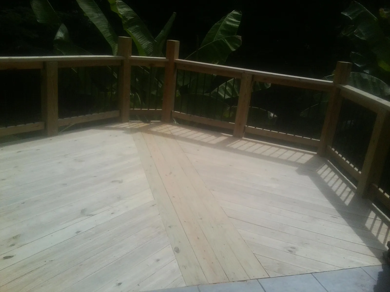 New wood deck and railing built off the back of a home in Garrett Park